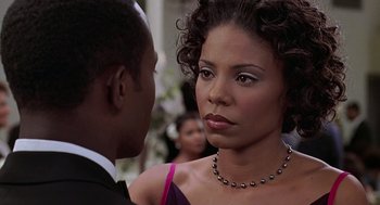 Movie still from “The Best Man” (1999), directed by Malcolm D. Lee – A man and a woman in formal wear looking at one another; Close Up shot, Over the shoulder angle