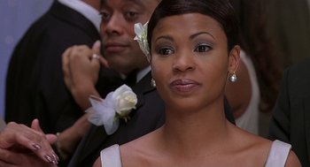 Movie still from “The Best Man” (1999), directed by Malcolm D. Lee – A person wearing a suit and tie; Close Up shot, Over the shoulder angle