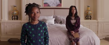 Movie still from “The Best Man Holiday” (2013), directed by Malcolm D. Lee – Two women sitting on a bed in a bedroom; Medium shot, Over the shoulder angle