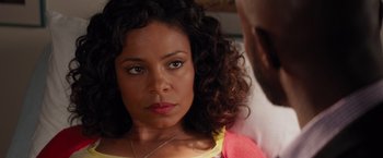Movie still from “The Best Man Holiday” (2013), directed by Malcolm D. Lee – A person with curly hair and a necklace; Close Up shot, Over the shoulder angle