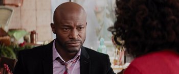 Movie still from “The Best Man Holiday” (2013), directed by Malcolm D. Lee – A person wearing a suit and tie; Close Up shot, Over the shoulder angle