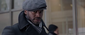 Movie still from “The Best Man Holiday” (2013), directed by Malcolm D. Lee – A man wearing a gray hat and a black coat; Close Up shot, Over the shoulder angle