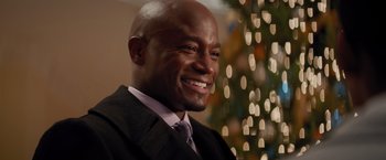 Movie still from “The Best Man Holiday” (2013), directed by Malcolm D. Lee – A person wearing a suit and smiling; Close Up shot, Over the shoulder angle