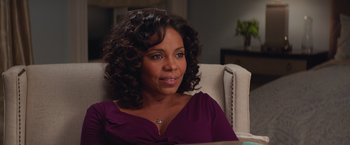 Movie still from “The Best Man Holiday” (2013), directed by Malcolm D. Lee – A person sitting in a chair; Close Up shot, Over the shoulder angle