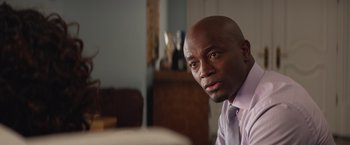 Movie still from “The Best Man Holiday” (2013), directed by Malcolm D. Lee – A man in a purple dress shirt and a tie; Close Up shot, Over the shoulder angle