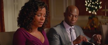 Movie still from “The Best Man Holiday” (2013), directed by Malcolm D. Lee – A man and a woman sitting next to each other on a couch; Medium shot, Over the shoulder angle