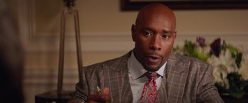 Movie still from “The Best Man Holiday” (2013), directed by Malcolm D. Lee – A man in a suit and tie holding a cigarette; Close Up shot, Over the shoulder angle