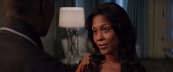 Movie still from “The Best Man Holiday” (2013), directed by Malcolm D. Lee – A person sitting in front of a lamp; Close Up shot, Over the shoulder angle