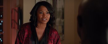 Movie still from “The Best Man Holiday” (2013), directed by Malcolm D. Lee – A woman with long black hair wearing a red and black robe; Close Up shot, Over the shoulder angle