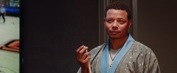 Movie still from “The Best Man Holiday” (2013), directed by Malcolm D. Lee – A man holding a wooden stick in his hand; Close Up shot, Low angle