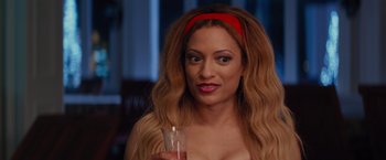 Movie still from “The Best Man Holiday” (2013), directed by Malcolm D. Lee – A woman holding a glass in her hand; Close Up shot, Over the shoulder angle