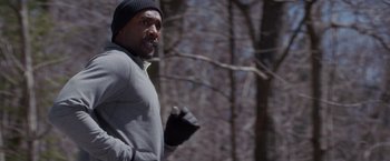 Movie still from “The Best Man Holiday” (2013), directed by Malcolm D. Lee – A man is running through the woods wearing gloves; Close Up shot, High angle