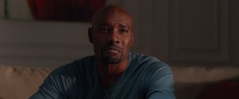 Movie still from “The Best Man Holiday” (2013), directed by Malcolm D. Lee – A man with a beard is looking at the camera; Close Up shot, Over the shoulder angle