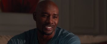Movie still from “The Best Man Holiday” (2013), directed by Malcolm D. Lee – A person smiling for the camera; Close Up shot, Over the shoulder angle