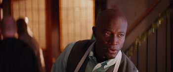 Movie still from “The Best Man Holiday” (2013), directed by Malcolm D. Lee – A man with a beard is looking at the camera; Close Up shot, Over the shoulder angle