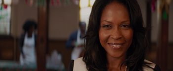 Movie still from “The Best Man Holiday” (2013), directed by Malcolm D. Lee – A person smiling for the camera; Close Up shot, Over the shoulder angle