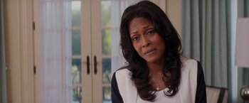 Movie still from “The Best Man Holiday” (2013), directed by Malcolm D. Lee – A woman with long black hair is looking at the camera; Close Up shot, Over the shoulder angle