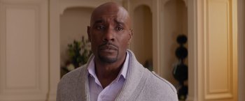 Movie still from “The Best Man Holiday” (2013), directed by Malcolm D. Lee – A man in a white dress shirt and a gray sweater; Close Up shot, Over the shoulder angle