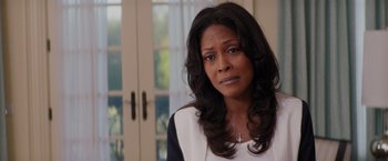Movie still from “The Best Man Holiday” (2013), directed by Malcolm D. Lee – A woman with long black curly hair wearing a white shirt; Close Up shot, Over the shoulder angle