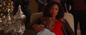 Movie still from “The Best Man Holiday” (2013), directed by Malcolm D. Lee – A man and a woman sitting next to each other in a chair; Medium shot, High angle