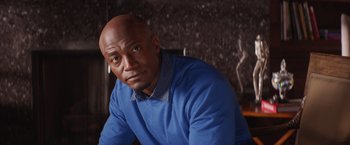 Movie still from “The Best Man Holiday” (2013), directed by Malcolm D. Lee – A bald man in a blue shirt is looking at the camera; Close Up shot, Low angle