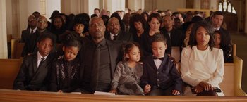 Movie still from “The Best Man Holiday” (2013), directed by Malcolm D. Lee – A group of people sitting in front of a group of other people; Medium shot, High angle