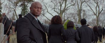 Movie still from “The Best Man Holiday” (2013), directed by Malcolm D. Lee – A man standing in front of a tree; Medium shot, Over the shoulder angle