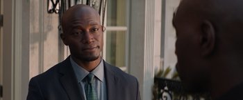 Movie still from “The Best Man Holiday” (2013), directed by Malcolm D. Lee – A man wearing a suit and tie standing outside; Close Up shot, Over the shoulder angle