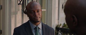 Movie still from “The Best Man Holiday” (2013), directed by Malcolm D. Lee – A man wearing a suit and tie standing outside; Close Up shot, Over the shoulder angle