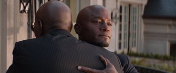 Movie still from “The Best Man Holiday” (2013), directed by Malcolm D. Lee – A man hugging another man in a black suit; Close Up shot, Over the shoulder angle