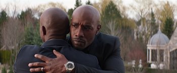 Movie still from “The Best Man Holiday” (2013), directed by Malcolm D. Lee – A man in a suit hugging another man in a suit; Close Up shot, Over the shoulder angle