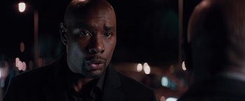 Movie still from “The Best Man Holiday” (2013), directed by Malcolm D. Lee – A person wearing a suit and tie; Close Up shot, Over the shoulder angle