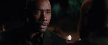 Movie still from “The Best Man Holiday” (2013), directed by Malcolm D. Lee – A person wearing a suit and tie; Close Up shot, Over the shoulder angle
