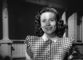 Movie still from “The Best Years of Our Lives” (1946), directed by William Wyler – An old photo of a young woman in a checkered dress; Close Up shot, Low angle