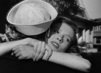 Movie still from “The Best Years of Our Lives” (1946), directed by William Wyler – A woman hugging another woman in a hat; Close Up shot, Low angle