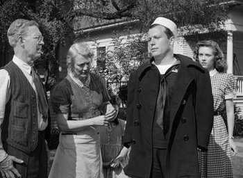 Movie still from “The Best Years of Our Lives” (1946), directed by William Wyler – An old black and white photo of a man and woman; Medium shot, Over the shoulder angle