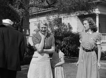 Movie still from “The Best Years of Our Lives” (1946), directed by William Wyler – An old photo of a woman and two girls; Medium shot, Over the shoulder angle