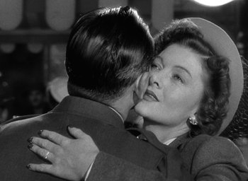 Movie still from “The Best Years of Our Lives” (1946), directed by William Wyler – An old photo of a man and a woman hugging; Close Up shot, Over the shoulder angle
