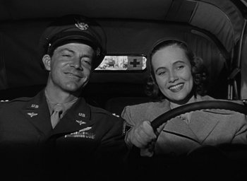 Movie still from “The Best Years of Our Lives” (1946), directed by William Wyler – A man and a woman sitting in the back of a car; Medium shot, Low angle