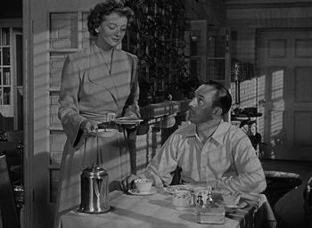 Movie still from “The Best Years of Our Lives” (1946), directed by William Wyler – An old black and white photo of a man and a woman; Medium shot, Low angle