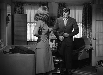 Movie still from “The Best Years of Our Lives” (1946), directed by William Wyler – A man and a woman standing in a living room; Medium shot, Over the shoulder angle