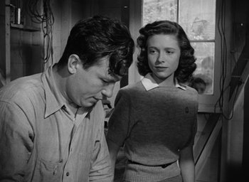 Movie still from “The Best Years of Our Lives” (1946), directed by William Wyler – A man and a woman standing next to each other in a room; Medium shot, Low angle