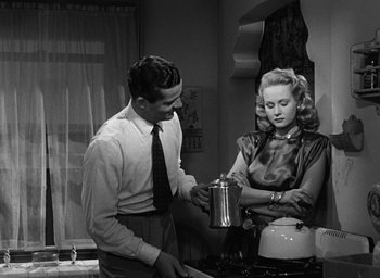 Movie still from “The Best Years of Our Lives” (1946), directed by William Wyler – A man and a woman in a kitchen with a coffee pot; Medium shot, Over the shoulder angle