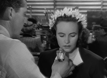 Movie still from “The Best Years of Our Lives” (1946), directed by William Wyler – A man putting a flower in a woman's hair; Close Up shot, Over the shoulder angle
