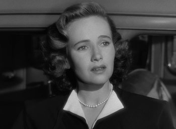 Movie still from “The Best Years of Our Lives” (1946), directed by William Wyler – An old photo of a woman in a car; Close Up shot, Low angle