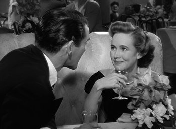 Movie still from “The Best Years of Our Lives” (1946), directed by William Wyler – A man and a woman sitting at a table with a glass of wine; Close Up shot, Over the shoulder angle