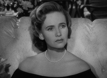 Movie still from “The Best Years of Our Lives” (1946), directed by William Wyler – An old photo of a woman in a black dress; Close Up shot, High angle