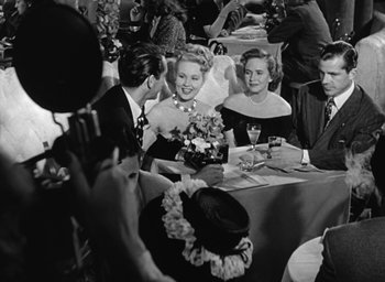 Movie still from “The Best Years of Our Lives” (1946), directed by William Wyler – A black and white photo of people sitting at a table; Medium shot, Over the shoulder angle