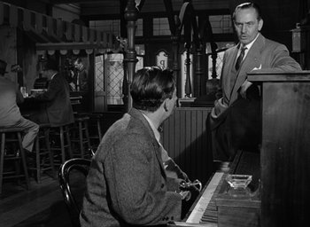 Movie still from “The Best Years of Our Lives” (1946), directed by William Wyler – Two men are playing a piano in a restaurant; Medium shot, Over the shoulder angle