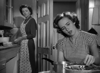 Movie still from “The Best Years of Our Lives” (1946), directed by William Wyler – Two women in a kitchen preparing a meal together; Medium shot, Low angle